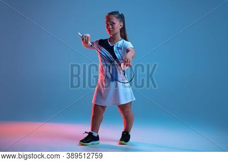 Leader. Beautiful Dwarf Woman Practicing In Badminton Isolated On Blue Background In Neon Light. Lif