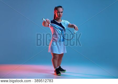 Leader. Beautiful Dwarf Woman Practicing In Badminton Isolated On Blue Background In Neon Light. Lif