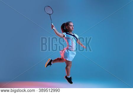 Action. Beautiful Dwarf Woman Practicing In Badminton Isolated On Blue Background In Neon Light. Lif