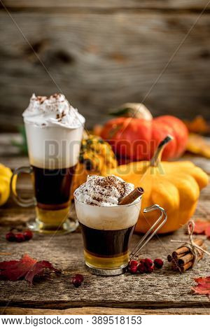 Pumpkin Latte With Cinamon Powder And Delicious Flavours On The Old Textured Wood Table With Colorfu