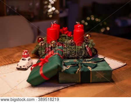 Christmas gifts, candles and toys and on wooden tables for Christmas celebrations