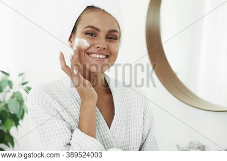 A Beautiful Young Woman With Vitiligo On Her Hands In A Bathrobe And With A Towel On Her Head Applie