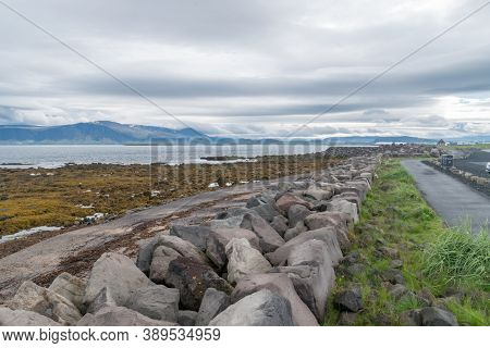 Shore Walk Along Rocks At Cloudy Day At Seltjarnarnes, Iceland.