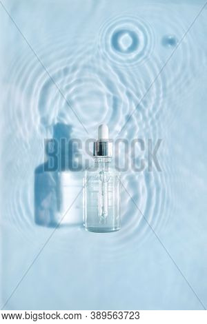 Cosmetic Spa Medical Skin Care, Bottle For Serum, Micellar Toner And Emulsion On Water Texture Backg
