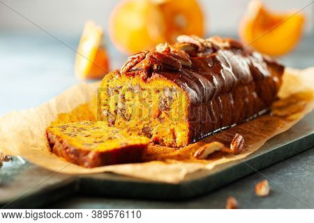 Delicious pumpkin pecan and raisin cake on cutting board. Loaf of pumpkin bread.