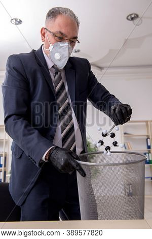 Old male boss employee working during pandemic