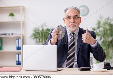 Old male boss employee working during pandemic