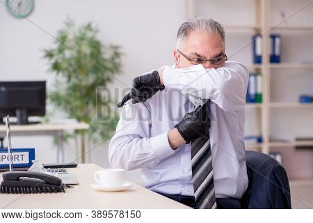 Old male boss employee working during pandemic