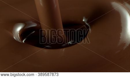Detail of pouring hot chcocolate. Studio macro shot.