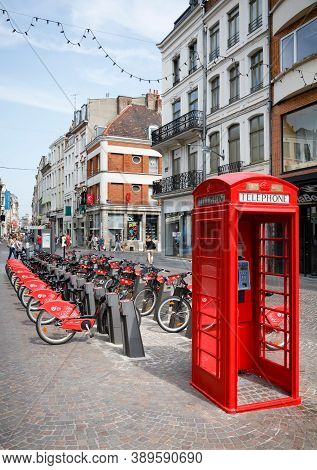Lille, France - July 18, 2013. Free Bike Rental Station And Red British Telephone Box In A Street In