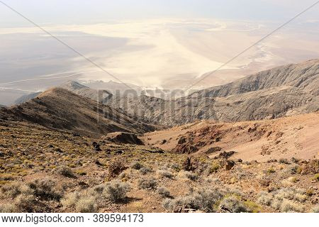 Arid Mountain Range On A Barren Windswept Ridge Overlooking The Salt Flats On Badwater Dry Lakebed T