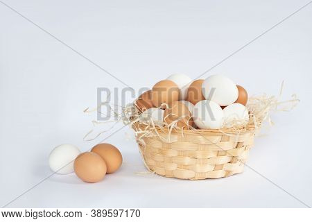 Close-up View Of Raw Chicken Eggs In Egg Box On White, Beige, Isolated Background. Mix White And Bro