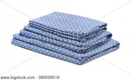Stack of blue cotton bedding set isolated on white