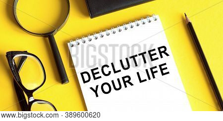 Declutter Your Life - Motivational Handwriting On A Napkin With Magnifier And Glasses And Pencil