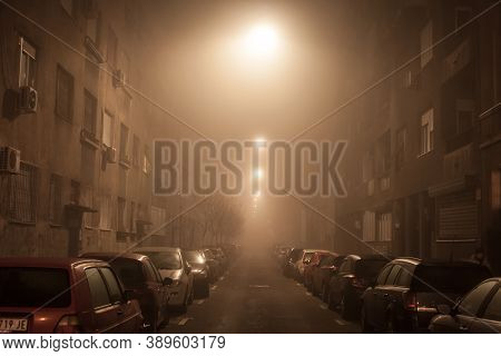 Belgrade, Serbia - January 15, 2020: Cars Parked In A Street During A Smoggy Night In Belgrade. Belg
