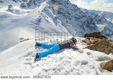 Acrophobia Woman Lie On Top Of A Snowy Rock Cliff Edge. Fighting The Fear Of Heights Concept