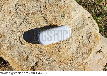 Grand Canyon, Usa - 09.07.2020: White Headphone Box Of Huawei Freebuds 3i On Stone. Top View.