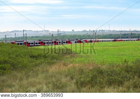 Anapa, Russia - 09.26.2020: Two Russian Railways Trains Move On Rails Among Fields And Meadows Towar