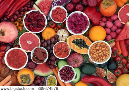 Immune boosting healthy food for good health high in lycopene, anthocyanins, antioxidants, vitamins, minerals & dietary fibre. With fruit & vegetables, loose & in round bowls. Plant based vegan foods.