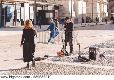 Street Musician Gianni Guaglio Is Going To Play The Theremin Near Duomo Cathedral. Milan City During