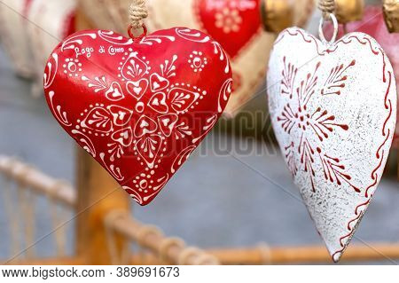 Souvenir Heart. Traditional Alpine Cow Bells In The Shape Of Heart On Street Market. Text On Heart M