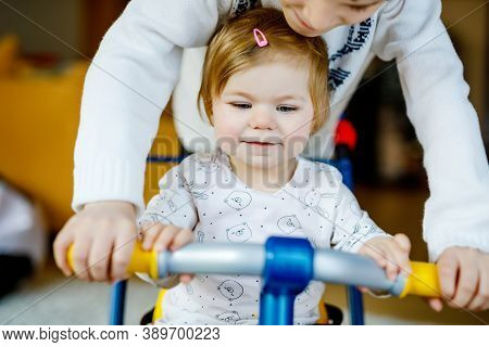 Little Kid Boy Pushing Bycicle Or Tricycle With Cute Baby Sister. Toddler Girl And Brother Playing T
