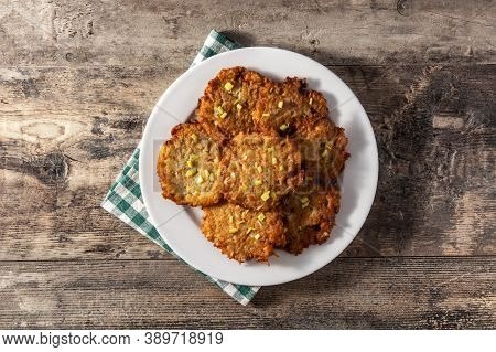 Traditional Jewish Latkes Or Potato Pancakes On Wooden Table.top View