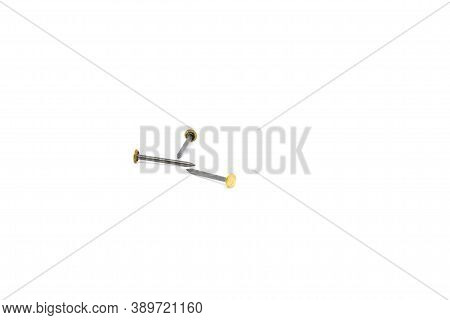 Three Tacks On A White Background. Three Picture Nails On A White Background.three Gold-colored Head