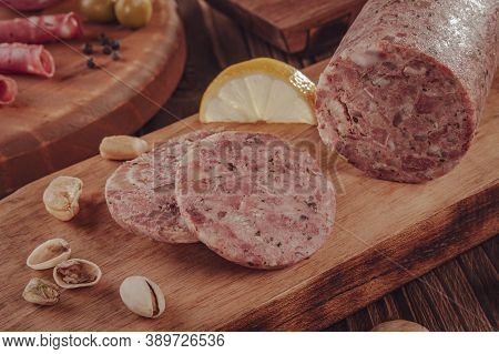 Slices Of White Pudding With Pistachios On Cutting Board