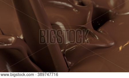 Detail of pouring hot chcocolate with splash. Studio macro shot.