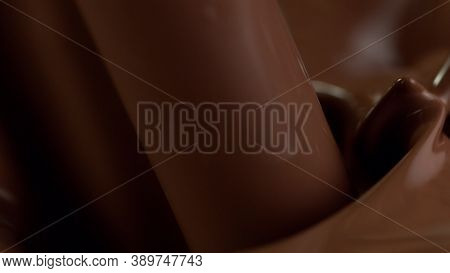 Detail of pouring hot chcocolate with splash. Studio macro shot.