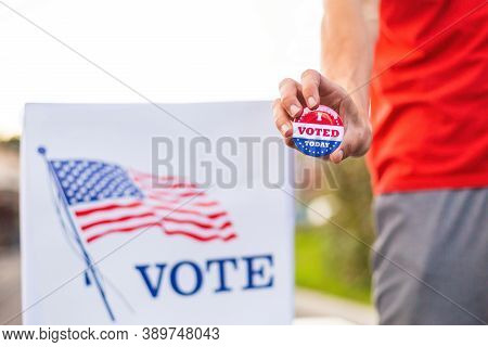 Hand Showing I Voted Today Badge At Ballot Box At American Elections.