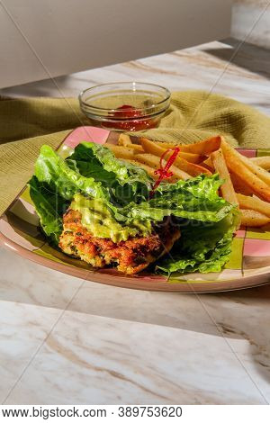 Avocado Chicken Burger Lettuce Wrap With Guacamole And Fries Served With Pink Limeade With Paper Str