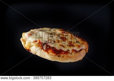 Fresh Baked Homemade English Muffin Pizza Flying Through The Air