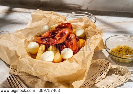 Peruvian Fast-food Salchipapas French Fries And Sliced Sausage With Hard-boiled Quail Eggs