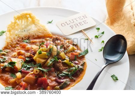 Hearty Italian Minestrone Soup With Sausage And Parmesan Cheese Crisp Plating