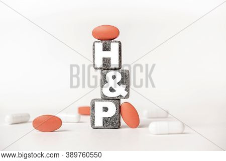 A Group Of White And Red Pills And Cubes With The Word Hp History And Physical Examination On Them,