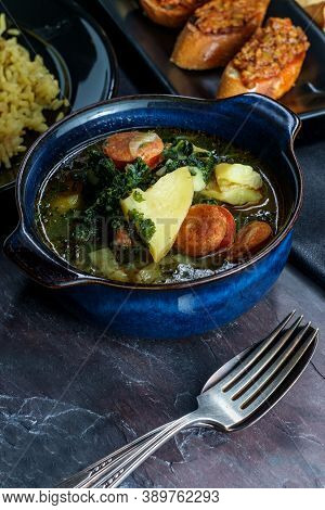 Traditional Portuguese Caldo Verde Chourico Soup With Orzo Rice Pilaf And Petiscos