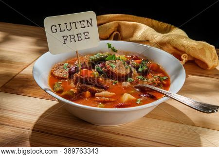 Hearty Italian Minestrone Soup With Sliced Sausage And Vegetables