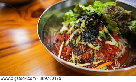 Close Up Image Of Korean Traditional Food, Spicy Cold Soba Noodles, Bibim Guksu, On A Stainless Stee
