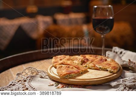 Glass Of Red Wine And Pieces Of Placida With Cottage Cheese Or Vertuta On A Wooden Tray, Close-up, T
