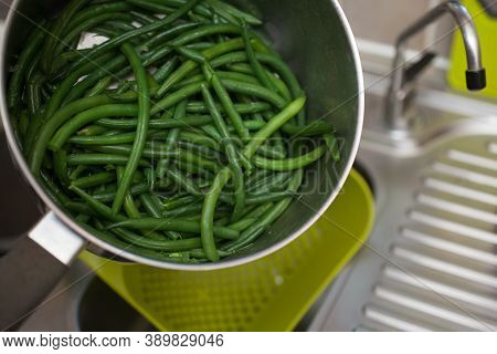 Green Beans Being Drained Of Water After Cooking In A Pan