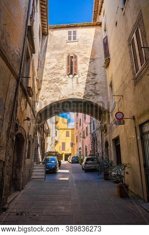 Modern Cars Parked In Narrow Street Of Medieval Town Of Orte In Italy