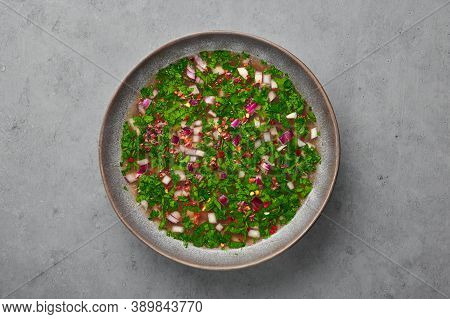 Pachi Pulusu In Gray Bowl On Concrete Table Top. Raw Tamarind Rasam Is Indian Cuisine Soup Dish. Asi