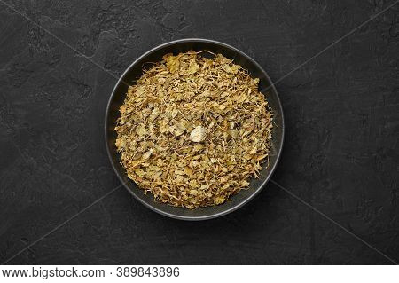 Dry Kasuri Methi Or Fenugreek In Black Bowl On Dark Slate Table Top. Dried Fenugreek Is Is The Popul