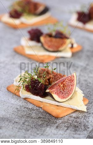 Cracker With A Slice Of Camembert, Jam, Figs And Nuts.
A Great Snack Idea For A Holiday, Picnic Or P