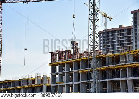 Preparing To Pour A Bucket Of Concrete Into Formwork.tower Crane Lifting Cement Bucket During Constr