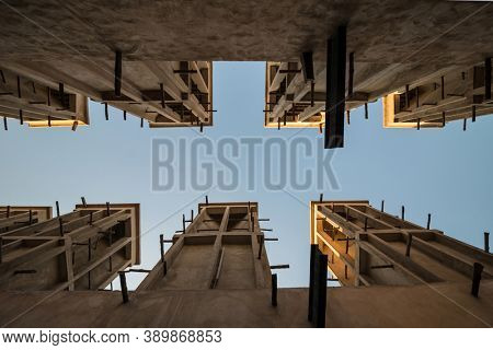 Typical middle eastern wind towers from ancient arabic architecture. Sky visible through row of wind towers shot from below angle.