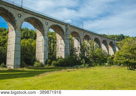 Train Viaduct In Altenbeken,  North Rhine Westphalia, Germany. Old Stone Railway Surrounded By Green