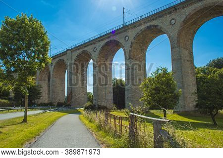 Train Viaduct In Altenbeken,  North Rhine Westphalia, Germany. Old Stone Railway Surrounded By Green